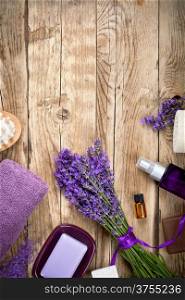 Lavender spa beauty treatment products on wooden table. Empty room for text. Top view
