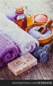 Lavender spa - essential oil, seasalt, violet towels and handmade soap. Lavender spa concept