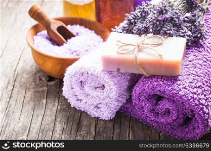 Lavender spa - essential oil, seasalt, violet towels and handmade soap. Lavender spa concept