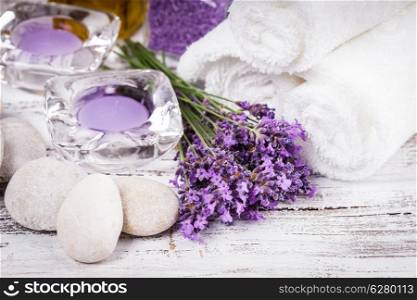 Lavender spa with rebbles, candles and white towels