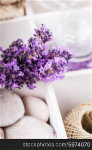 Lavender spa with rebbles, candles and white towels in a box