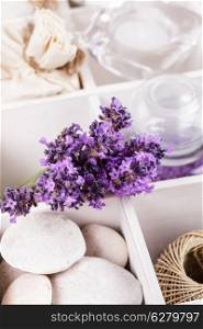 Lavender spa with rebbles, candles and white towels in a box