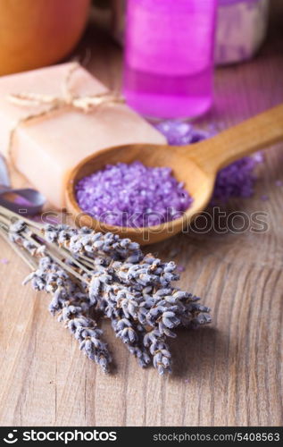 Lavender treatment soap and sea salt on wooden table