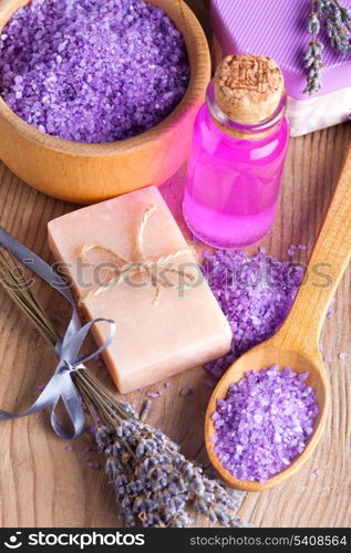 Lavender treatment soap and sea salt on wooden table