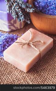 Lavender treatment soap and sea salt on wooden table