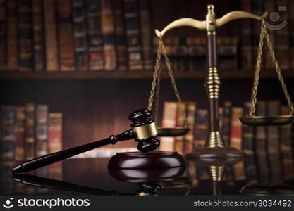 Law and justice concept, Brown wooden background, beautiful refl. Law theme, mallet of the judge, wooden desk, books