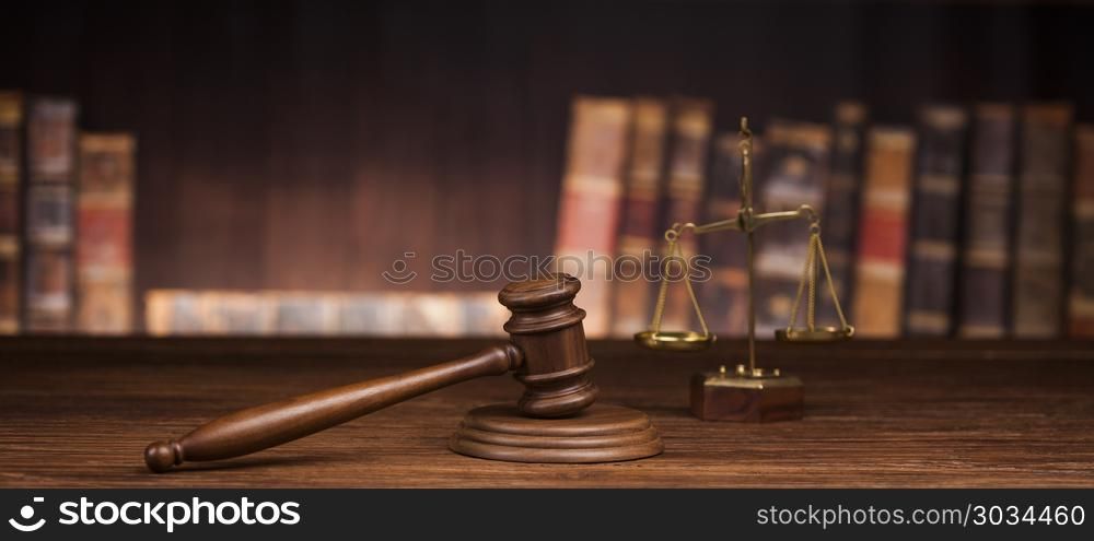 Law and justice concept, Brown wooden background. law theme, mallet of the judge, justice scale, books, wooden desk