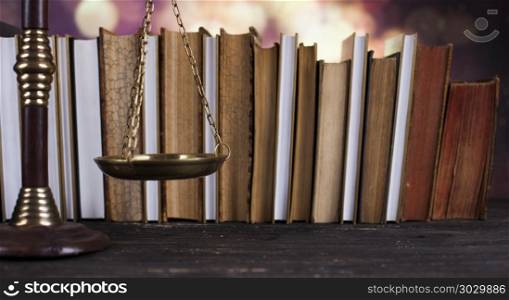Law book, mallet of the judge, justice scale, wooden desk backgr. Law and justice concept, legal code and scales