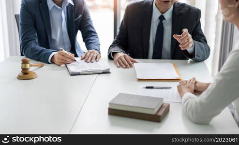 law concept the businessman, a man with the black suit, having a law consultation with the law officer, a man in deep blue suit and his assistant, a man in white shirt.