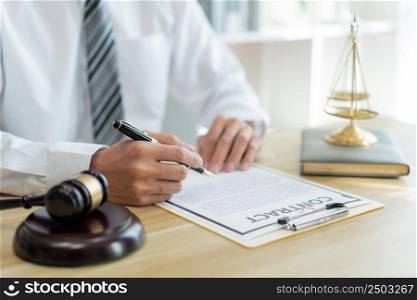 Law consultancy concept A male prosecutor reading the new version of contract thoroughly at his desk