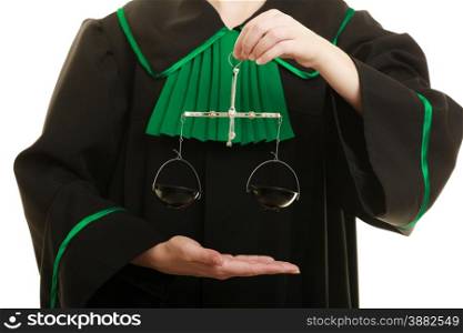 Law court concept. Woman lawyer attorney wearing classic polish black green gown holds scales. Femida - symbol sign of justice closeup