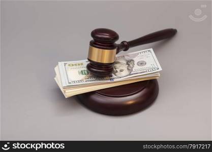 Law gavel on a stack of dollars isolated on gray