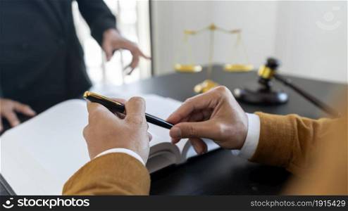 law,libra scale and hammer on the table, 2 lawyers are discussing about contract paper, law matters determination, holding pen.