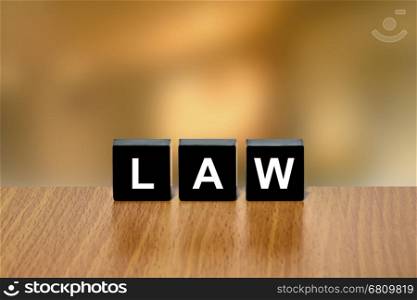 law on black block with blurred background