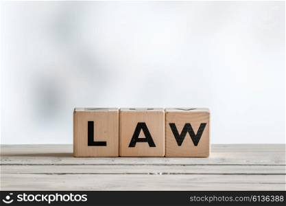 Law sign on a wooden desk on white background