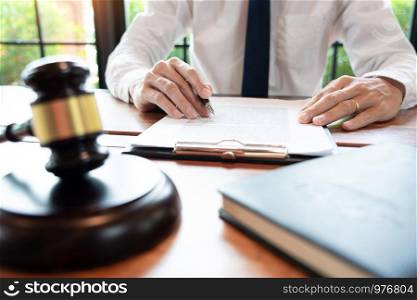 lawyer or judge business man working with paperwork agreement contract and gavel in Courtroom, Justice and Law firm Notary public concept.