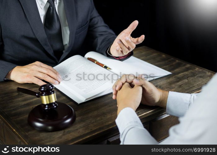 Lawyer or judge consult meeting with client at a law firm about legal legislation in courtroom with Judge gavel and Gold brass balance scale