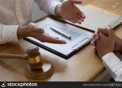 Lawyer present client with contract papers on the table in office. consultant lawyer, attorney, court judge, concept.