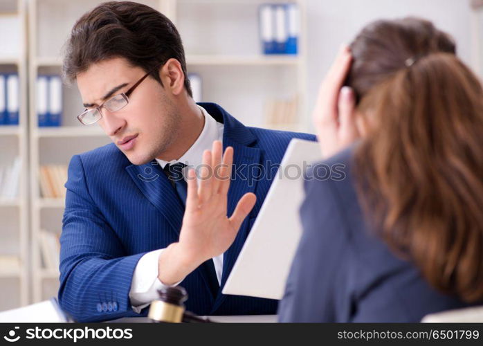 Lawyer talking to his client in office