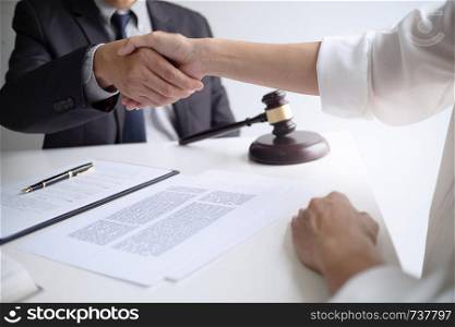 lawyer with client hands shaking in courtroom, legal and justice concept.