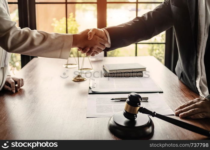 lawyer with client hands shaking in courtroom, legal and justice concept.