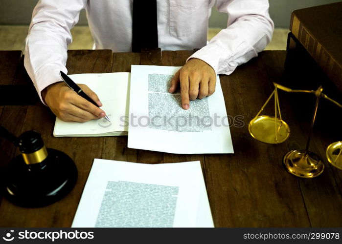 Lawyer working with contract papers on the table in office. consultant lawyer, attorney, court judge, concept.