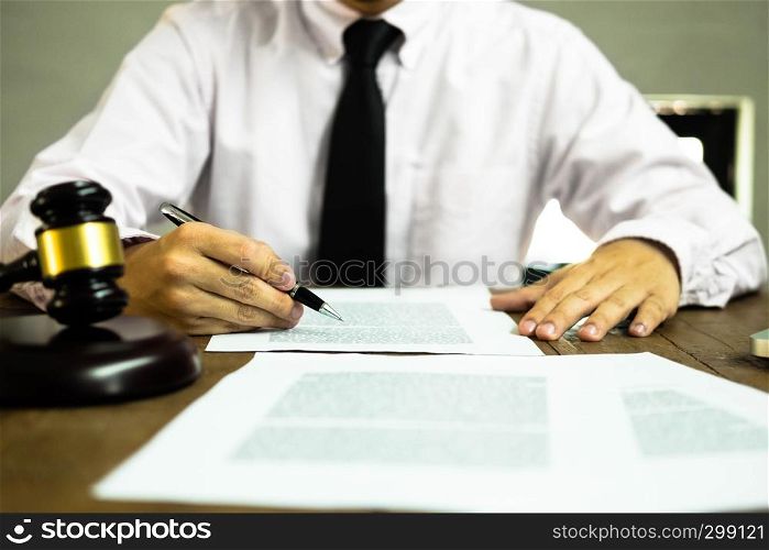 Lawyer working with contract papers on the table in office. consultant lawyer, attorney, court judge, concept.