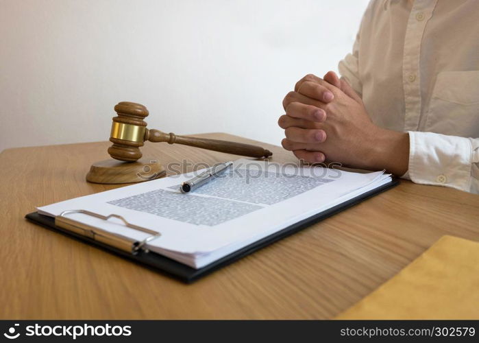 Lawyer working with contract papers on the table in office. consultant lawyer, attorney, court judge, concept.