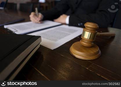 Lawyer working with contract papers on the table in office. consultant lawyer, attorney, court judge, concept.
