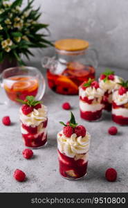 Layered dessert Trifle with vanilla cake, whipped cream and fresh raspberries