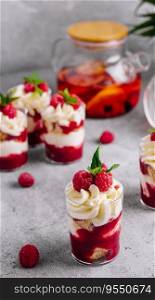 Layered dessert Trifle with vanilla cake, whipped cream and fresh raspberries