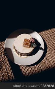 Layered honey cream cake on the table. Layered honey cream cake