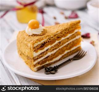 Layered orange cheesecake on plate on wooden table
