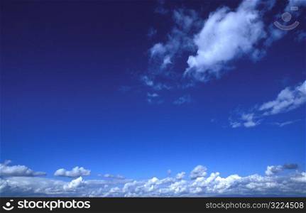Layers Of Clouds In A Clear Blue Sky