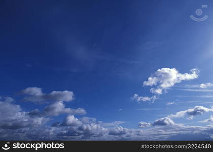 Layers Of Clouds In A Dark Blue Sky