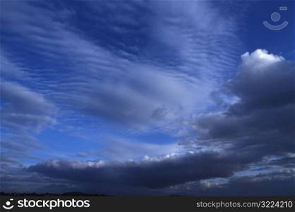 Layers Of Ribbed And Thick Clouds In Blue Sky