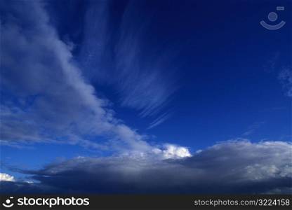 Layers Of Thin Cloud Wisps In A Clear Blue Sky