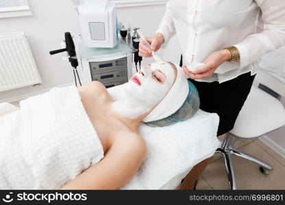 laying of mudpack in modern beauty salon