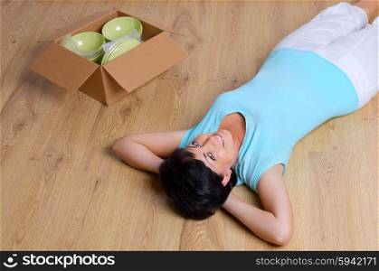 Laying woman and box with dishware