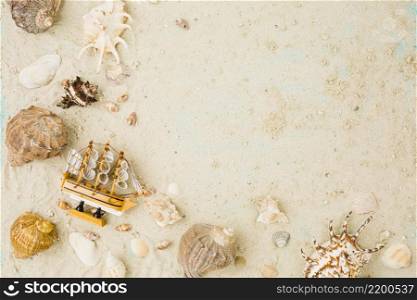 layout seashells toy boat sand
