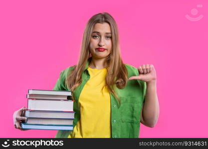 Lazy schoolgirl or student is dissatisfied with amount of books homework on pink background. Girl in displeasure, she is annoyed, discouraged frustrated by studies. High quality. Lazy schoolgirl or student is dissatisfied with amount of books homework on pink