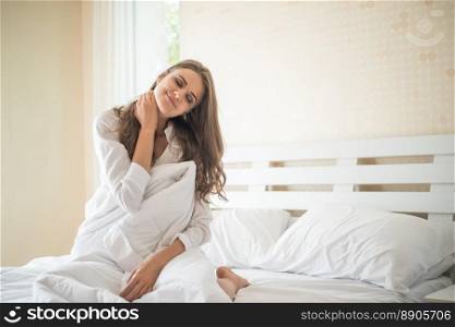 Lazy young woman sitting in bedroom