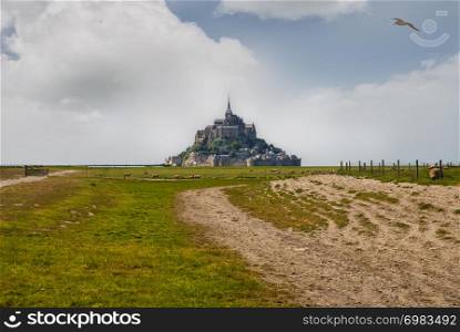 Le Mont Saint Michelewith blue sky and clouds, Normandy, northern France. Le Mont Saint Michelewith blue sky and clouds.
