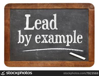 Lead by example - motivational words on a vintage slate blackboard