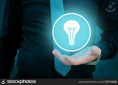 Leader think about business, creativity, business vision and headhunter concept. Businessman holding light bulb in his hand.. Leader think about business, creativity, business vision. Businessman holding light bulb in his hand