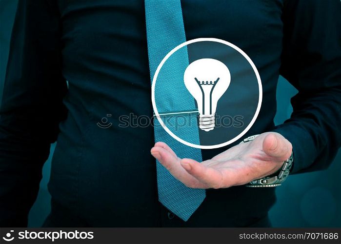 Leader think about business, creativity, business vision and headhunter concept. Businessman holding light bulb in his hand.. Leader think about business, creativity, business vision. Businessman holding light bulb in his hand