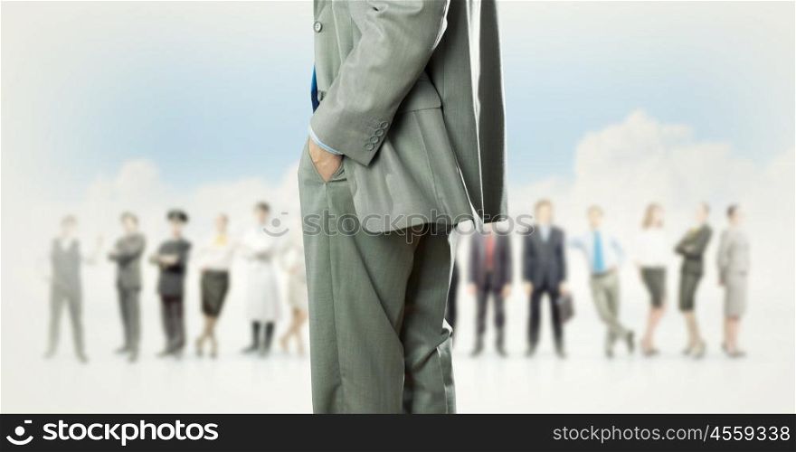 Leadership concept. Back view of confident businessman with business team at background