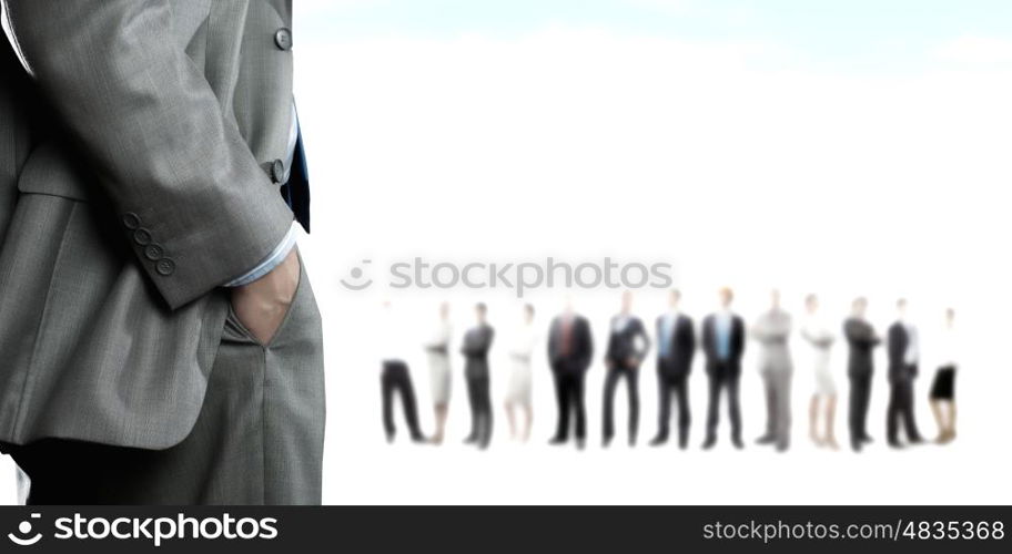 Leadership concept. Back view of confident businessman with business team at background