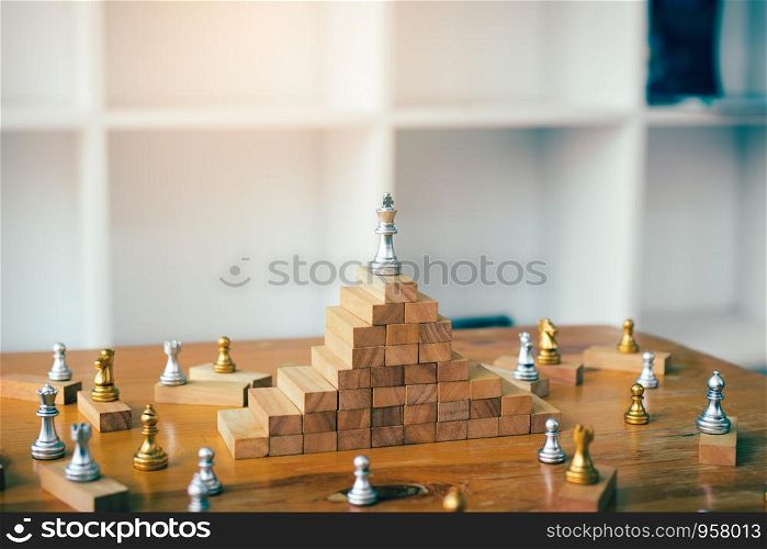 Leadership concept with king chess on top wooden block.