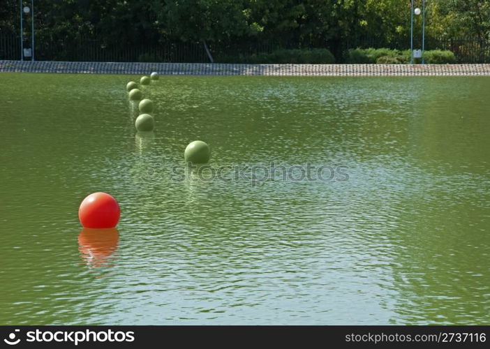 Leadership metaphor with balls in the pool. Buoys